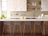 A sleek, modern kitchen with a kitchen island, stylish stools, and clean, organized shelves.