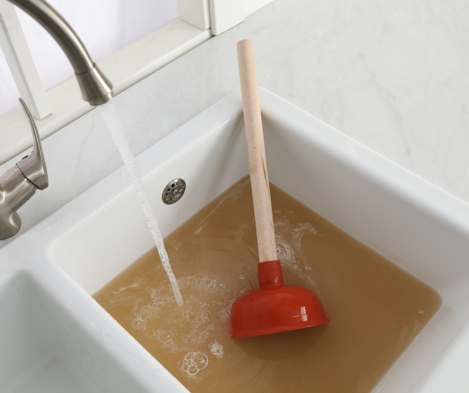 A clogged drain has backed up a sink with dirty water